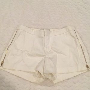 Guess white shorts with gold side zippers